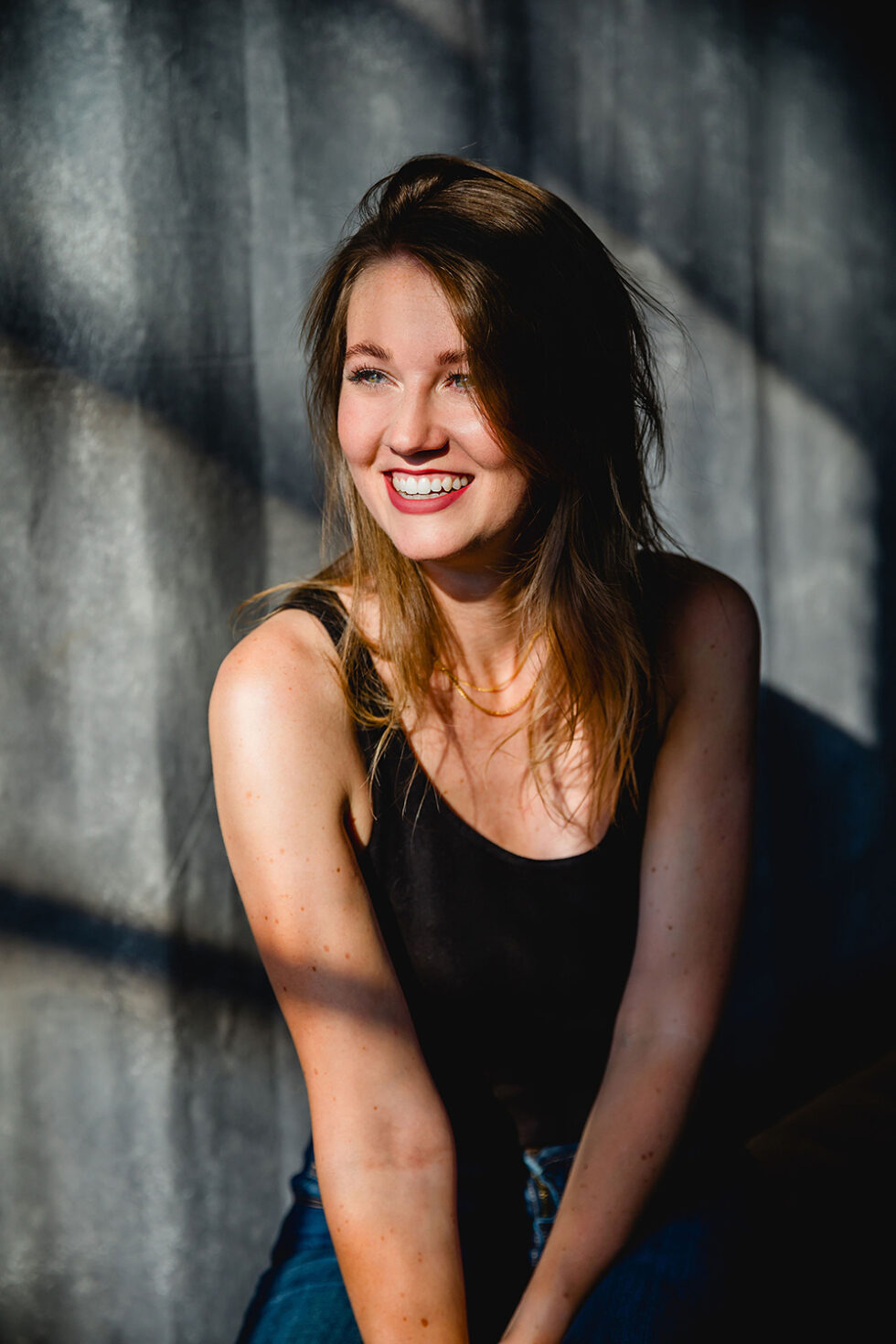 eine lachende schöne frau, die von der sonne angestrahlt wird